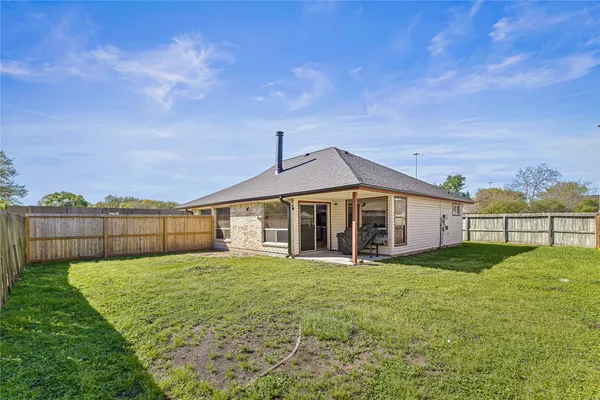a view of a house with a yard and porch
