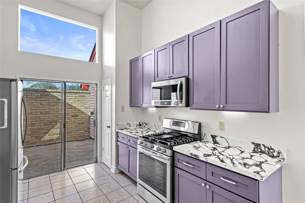 a kitchen with stainless steel appliances granite countertop a stove and a refrigerator
