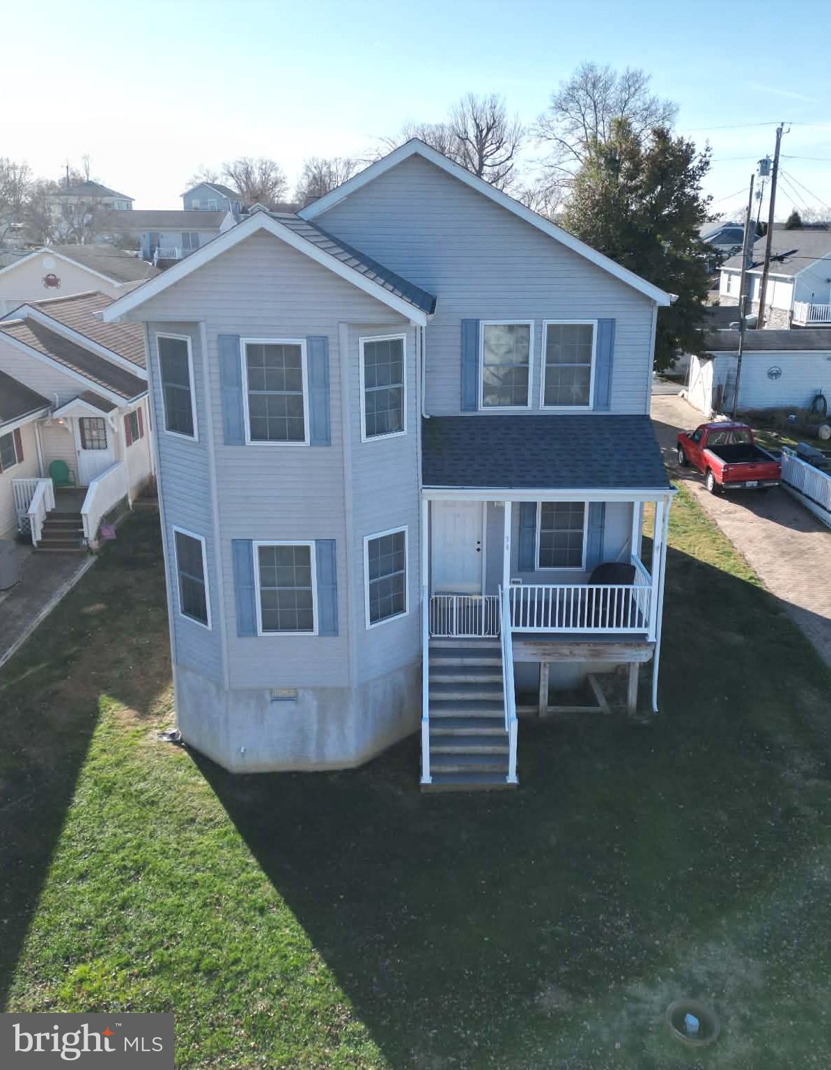 a view of a house with a yard and sitting area