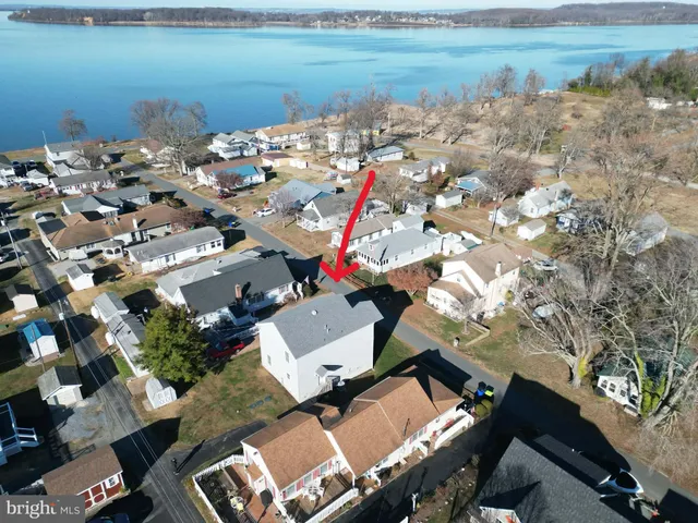 an aerial view of a house with a lake view