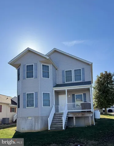 a view of balcony with wooden floor and fence