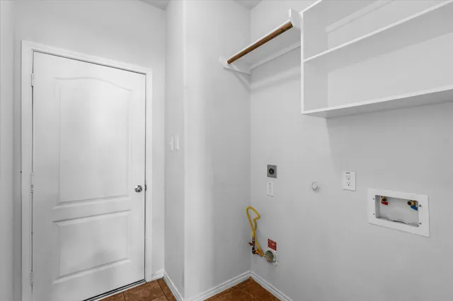 a view of storage and utility room with closet