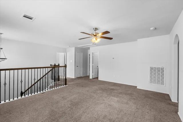 a view of an empty room with a fan