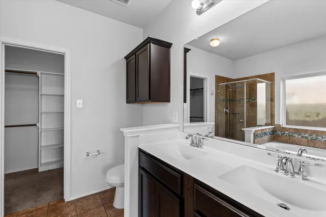 a bathroom with a sink double vanity and a toilet