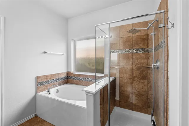 a bathroom with a tub and a shower