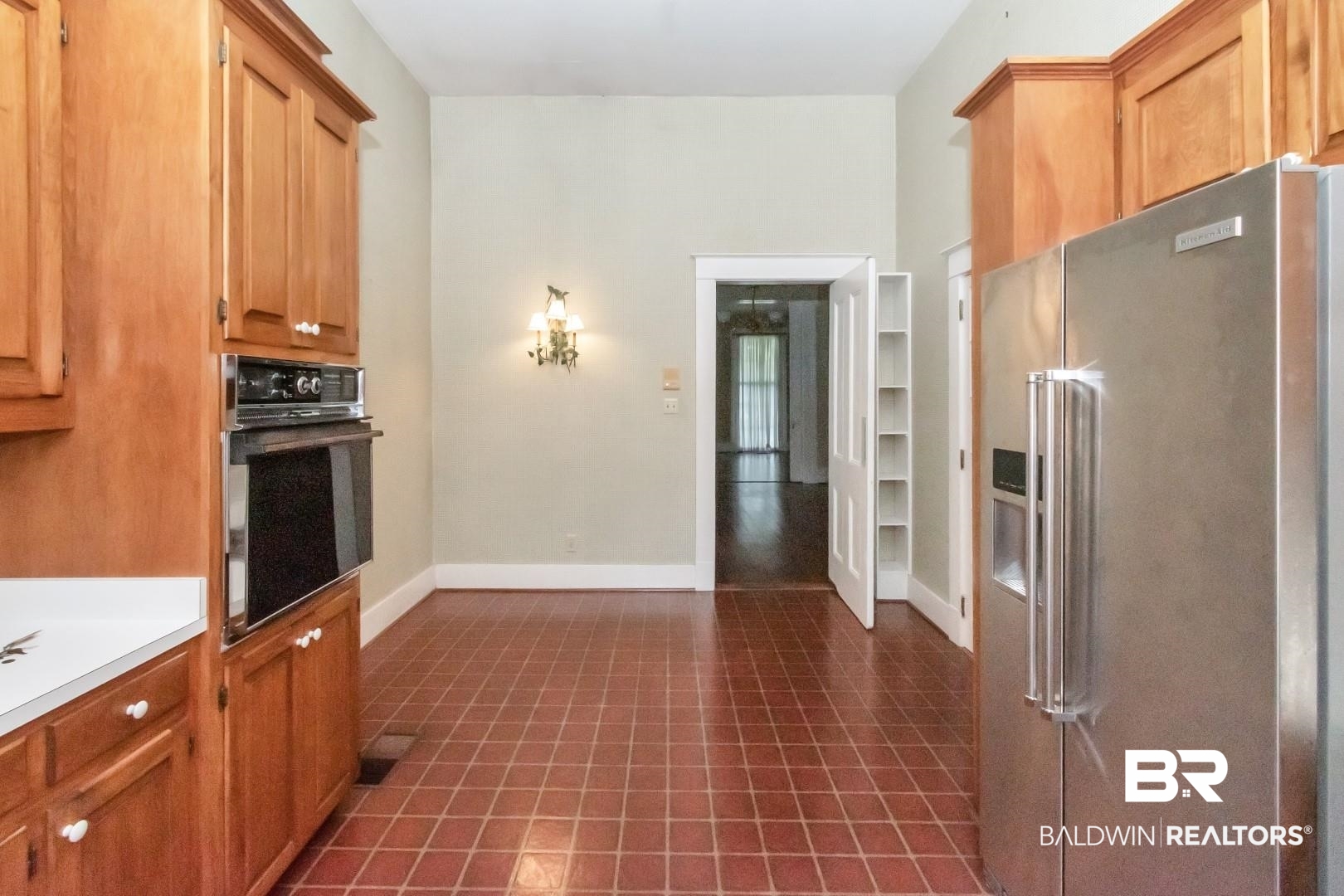 959 Dauphin Street Mobile, AL 36604 - Photo 13 of 43 Kitchen with dark tile patterned floors, high end refrigerator, and black oven