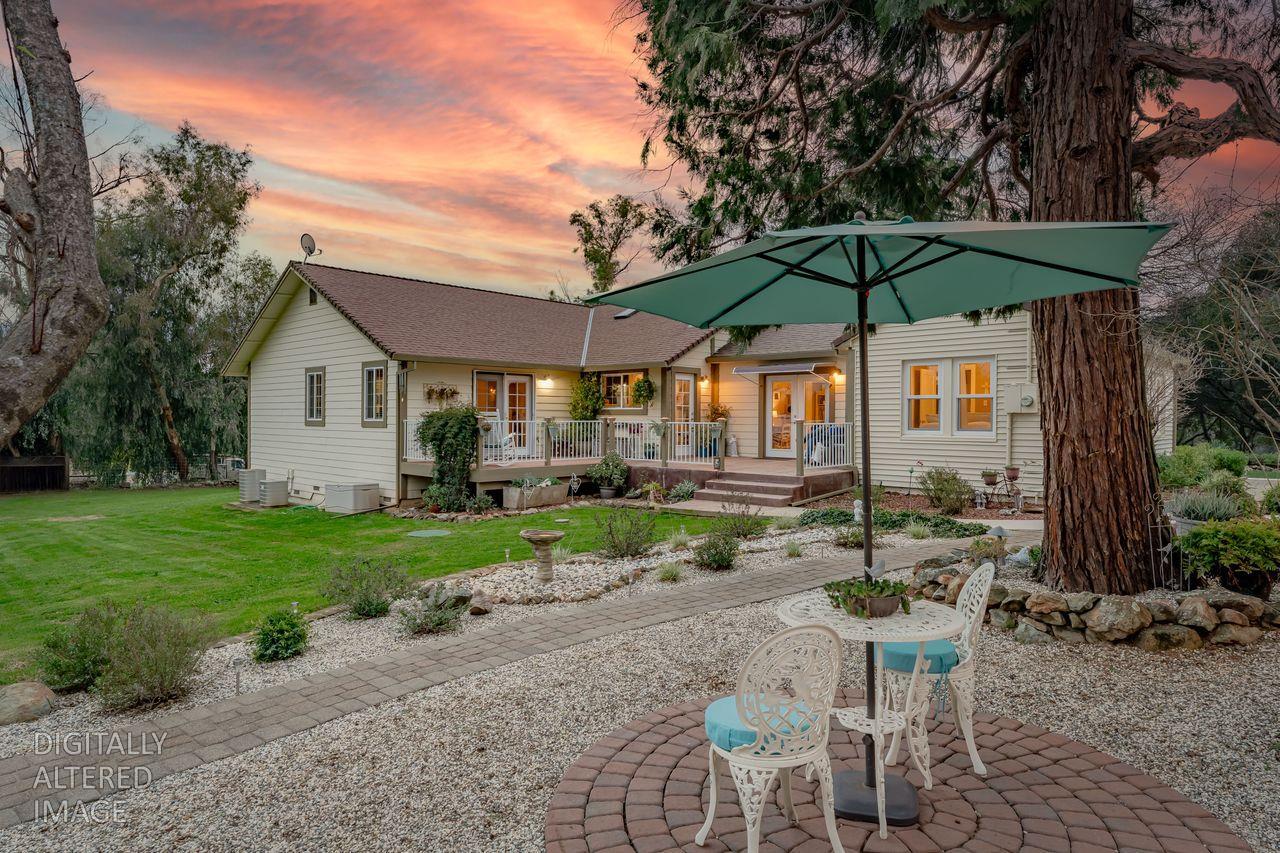 3740 Bell Road Auburn, CA 95602 - Photo 15 of 65 a view of a chair and table under an umbrella in backyard