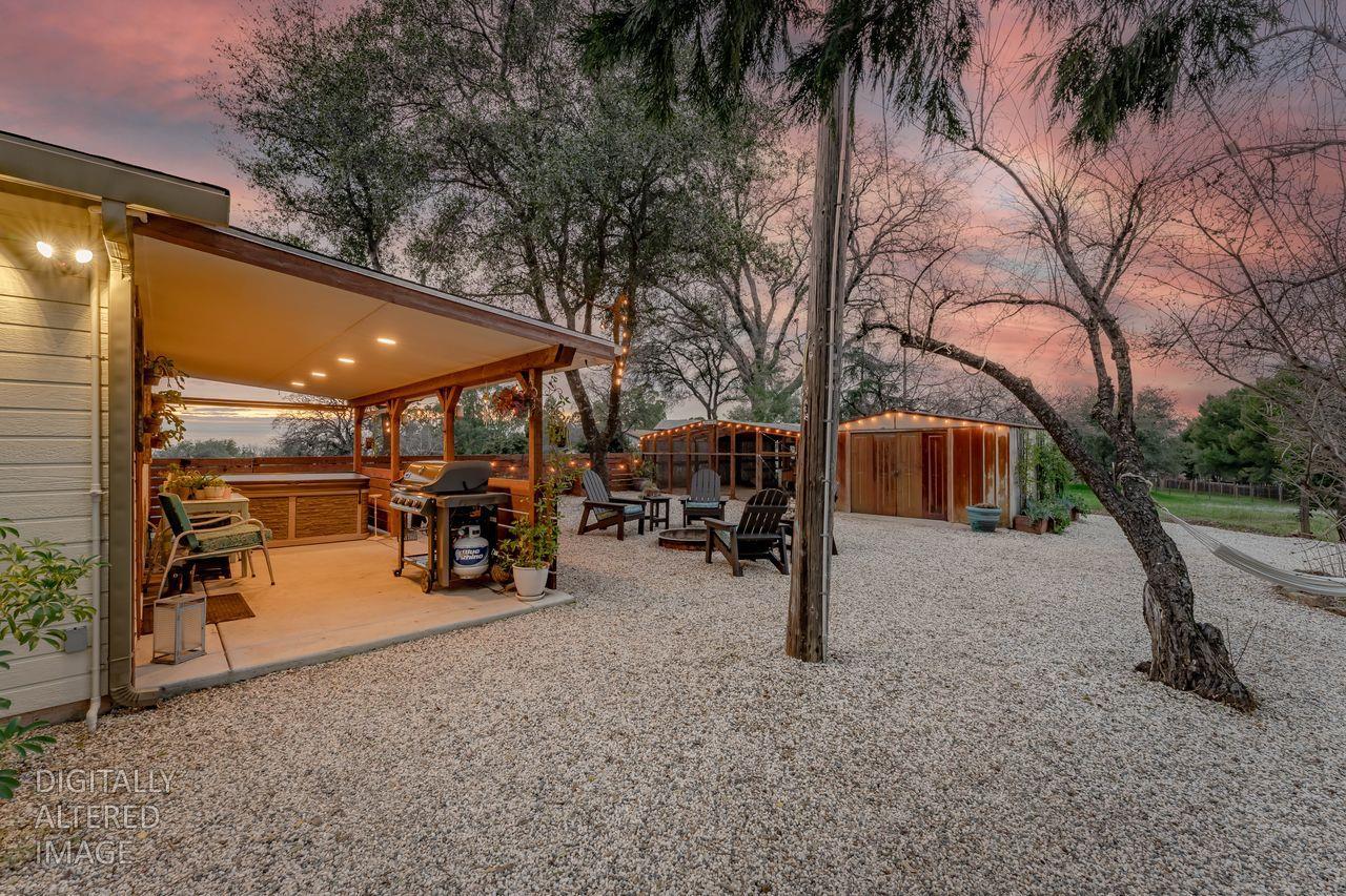 3740 Bell Road Auburn, CA 95602 - Photo 18 of 65 a view of a patio with table and chairs under an umbrella