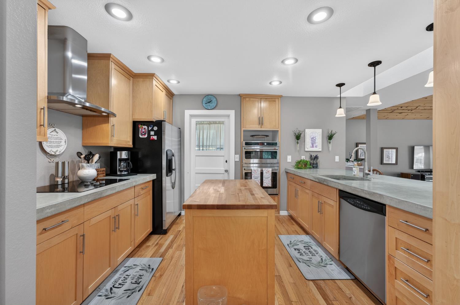 3740 Bell Road Auburn, CA 95602 - Photo 30 of 65 a large kitchen with stainless steel appliances kitchen island granite countertop a sink and cabinets