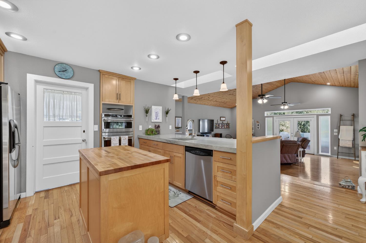 3740 Bell Road Auburn, CA 95602 - Photo 32 of 65 a kitchen with stainless steel appliances granite countertop a refrigerator a sink dishwasher and a stove with wooden floor