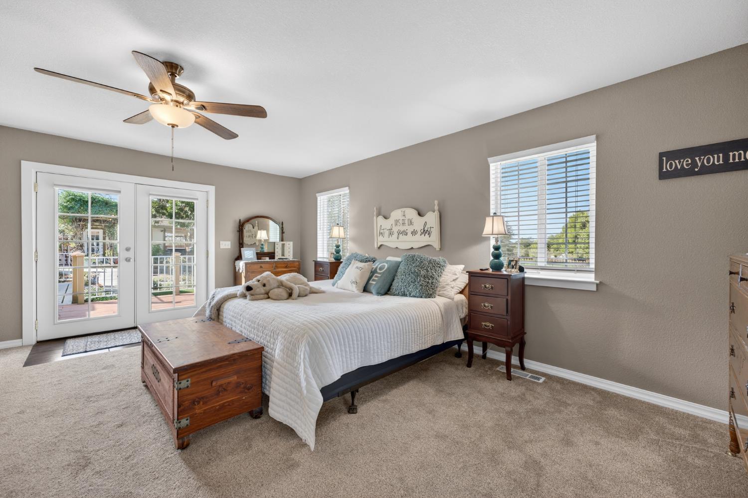 3740 Bell Road Auburn, CA 95602 - Photo 43 of 65 a spacious bedroom with a bed and a chandelier