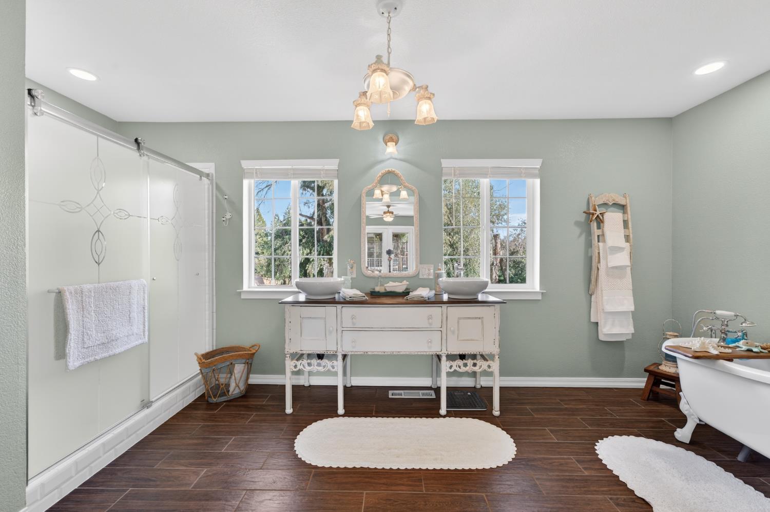 3740 Bell Road Auburn, CA 95602 - Photo 47 of 65 a dining room with wooden floor a chandelier a wooden table and chairs