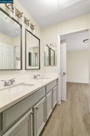 a bathroom with a double vanity sink and mirror