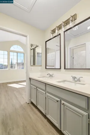 a bathroom with a granite countertop sink mirror and double