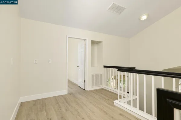 a view of a hallway with wooden floor