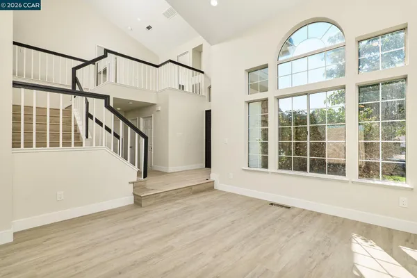 a view of an entryway with wooden floor and windows