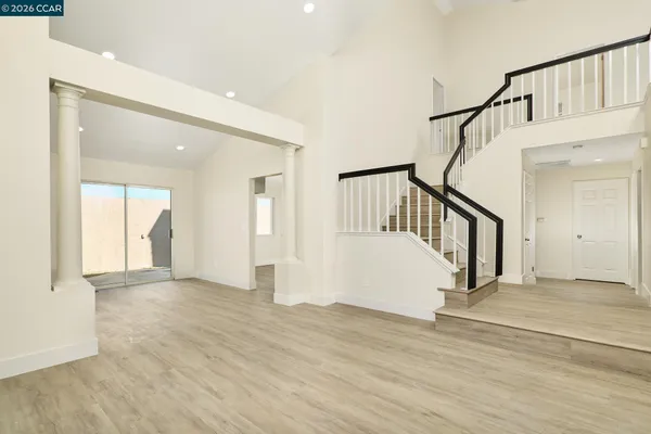 a view of an entryway with wooden floor