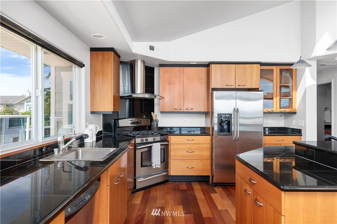 4913 Dundee Drive Anacortes, WA 98221 - Photo 15 of 40 a kitchen with stainless steel appliances granite countertop sink stove and refrigerator