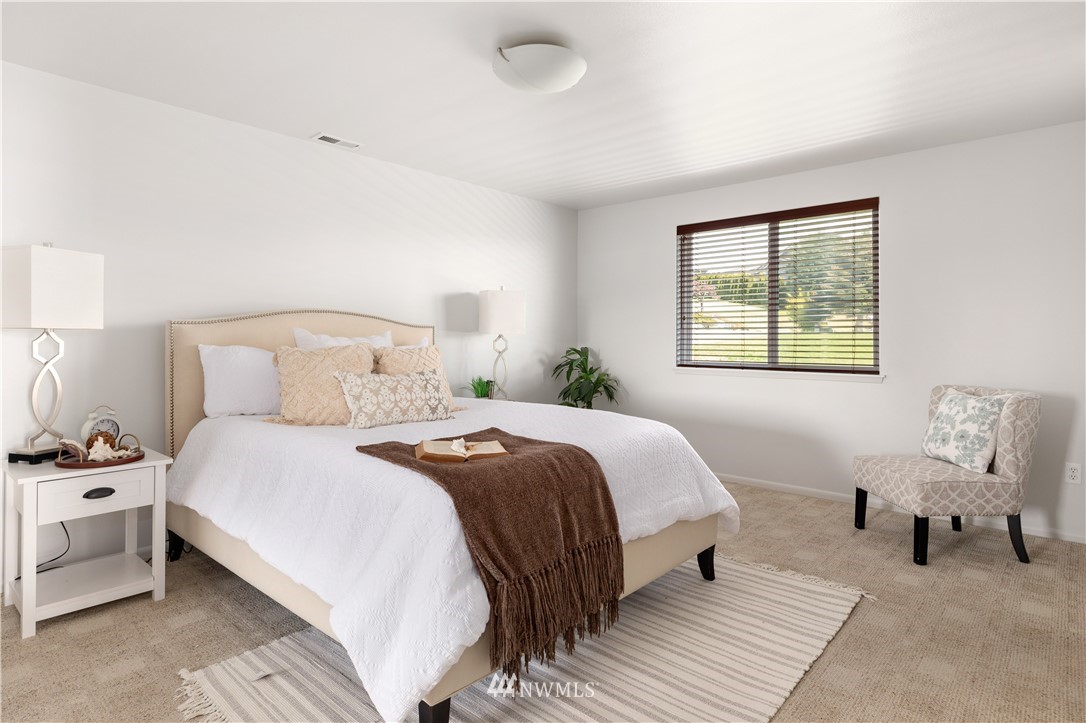 4913 Dundee Drive Anacortes, WA 98221 - Photo 18 of 40 a bedroom with a bed and a window