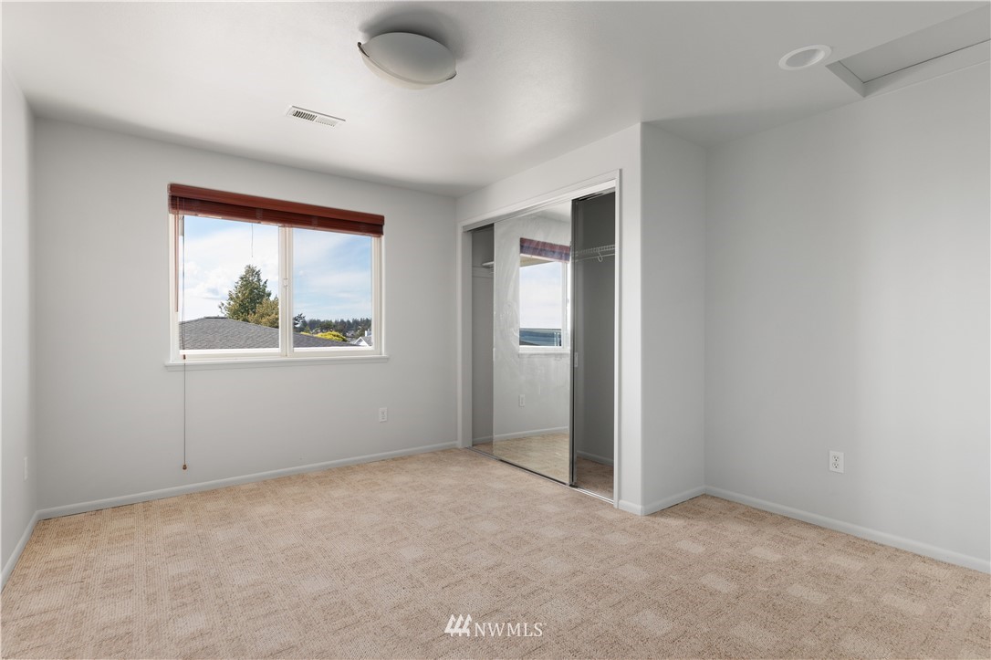 4913 Dundee Drive Anacortes, WA 98221 - Photo 24 of 40 an empty room with windows and closet