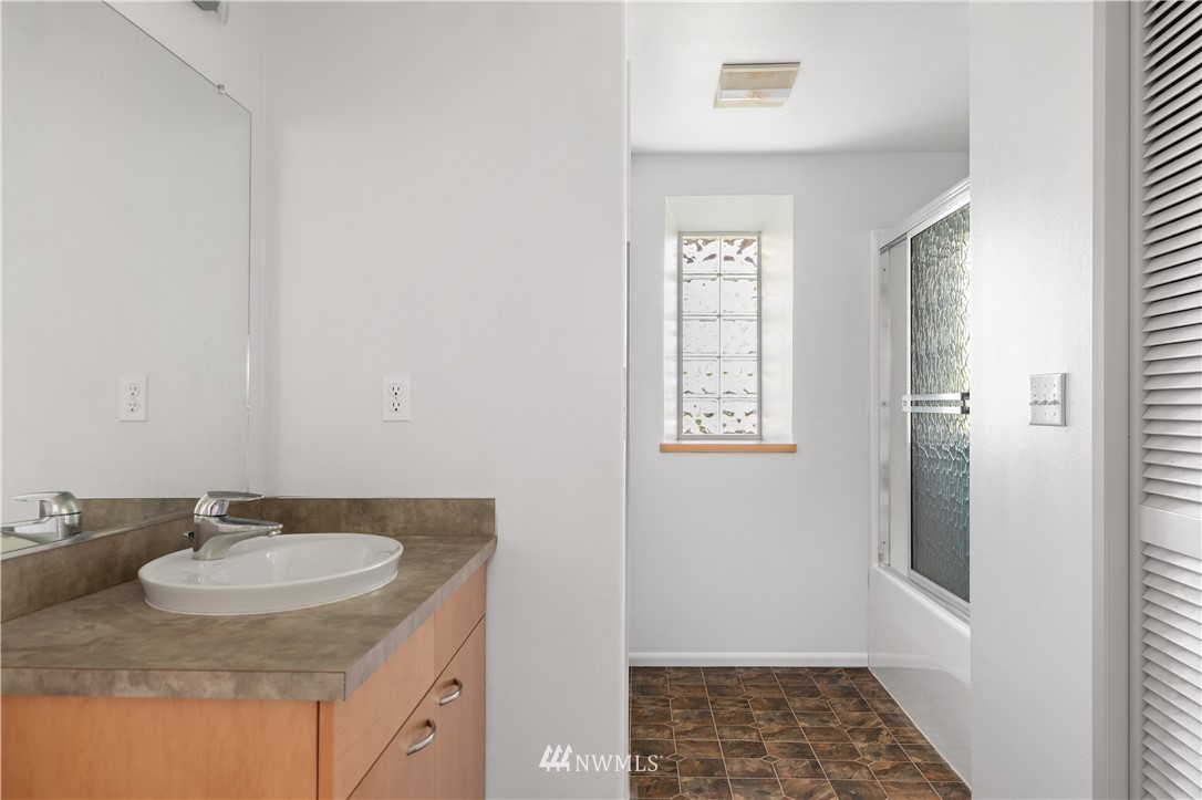 4913 Dundee Drive Anacortes, WA 98221 - Photo 34 of 40 a bathroom with a sink and a mirror