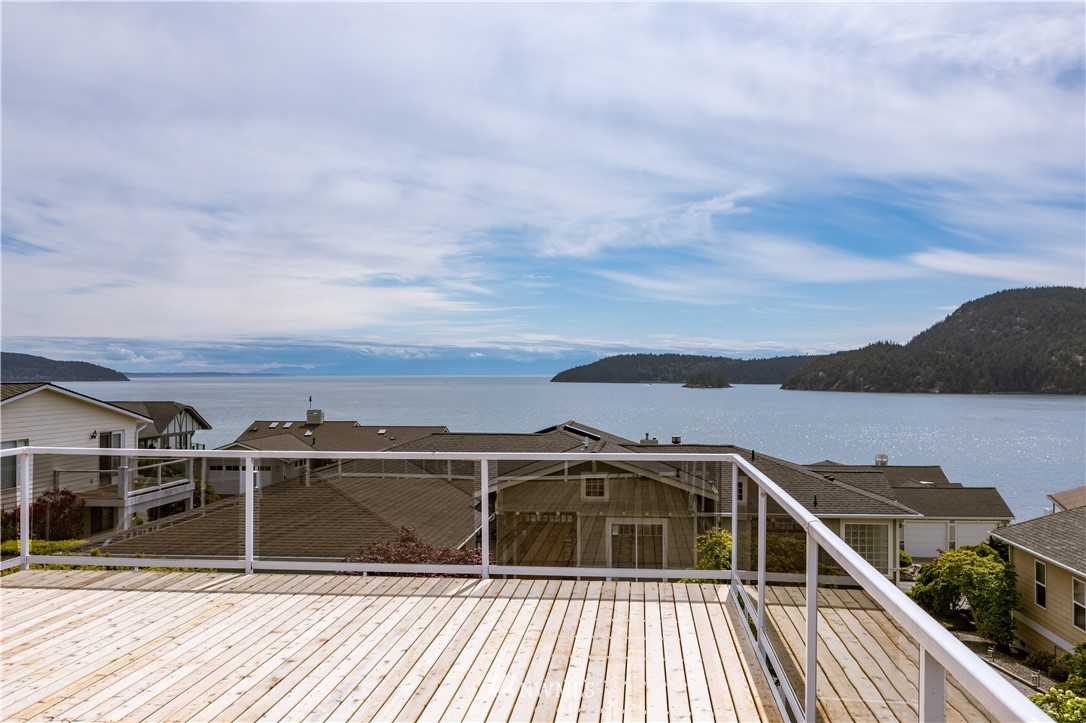 4913 Dundee Drive Anacortes, WA 98221 - Photo 36 of 40 a view of roof deck with wooden floor and city view