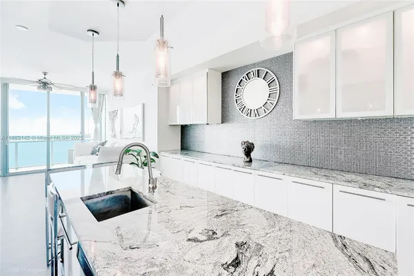 a living room with granite countertop furniture and a large window