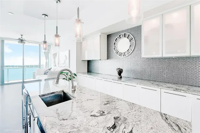 a living room with granite countertop furniture and a large window