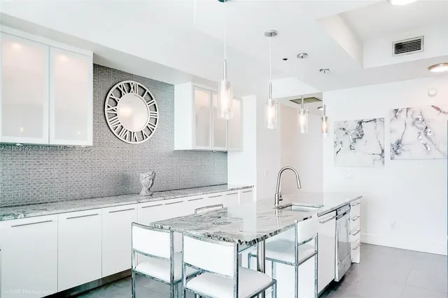 a kitchen with a sink and a clock on the wall