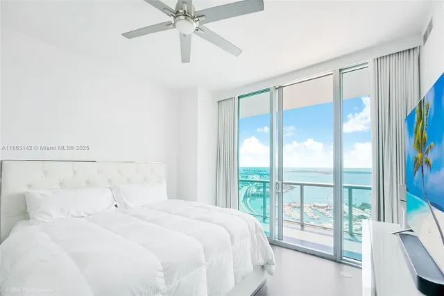 a bedroom with a large bed and a window