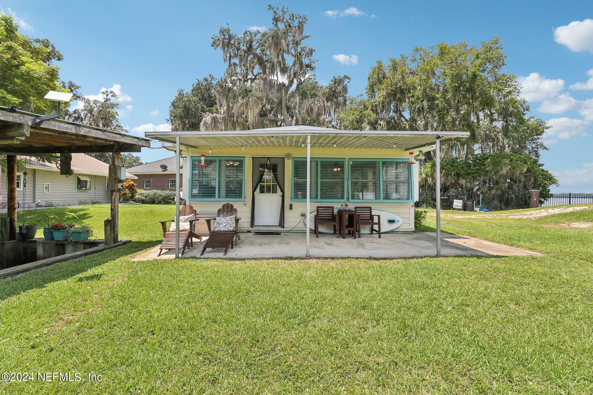 2870 Adams Road St. Augustine, FL 32092 - Photo 1 of 31 a view of a patio with table and chairs under an umbrella