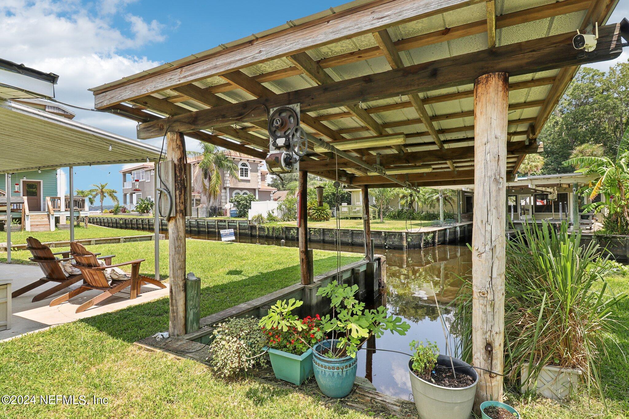 2870 Adams Road St. Augustine, FL 32092 - Photo 11 of 31 a view of a patio with table and chairs potted plants