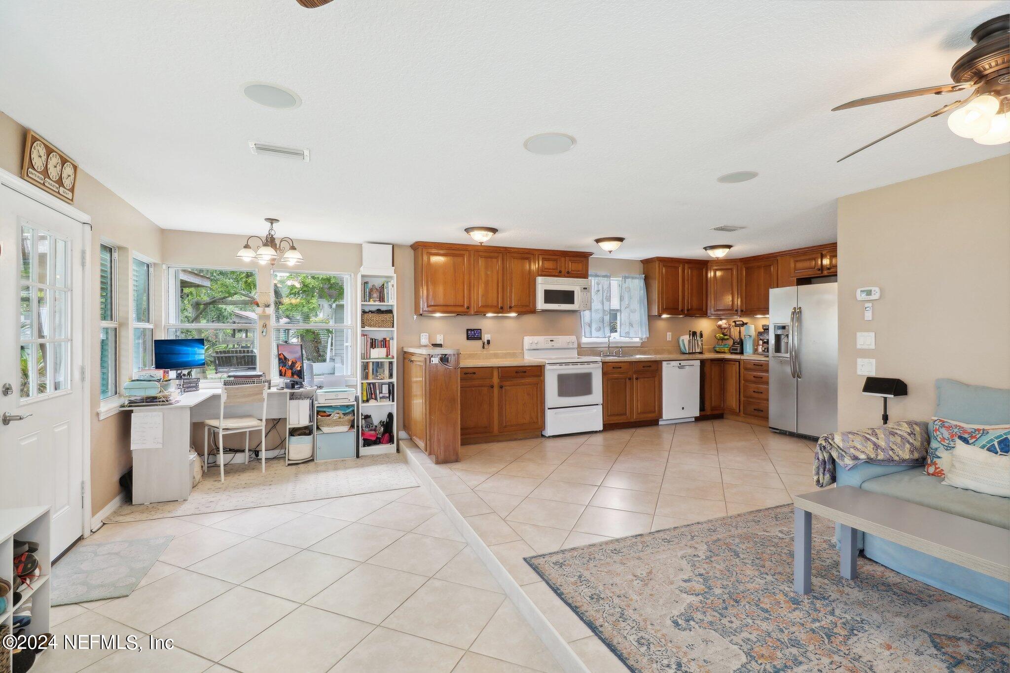 2870 Adams Road St. Augustine, FL 32092 - Photo 16 of 31 a living room with stainless steel appliances furniture cabinets and a kitchen view