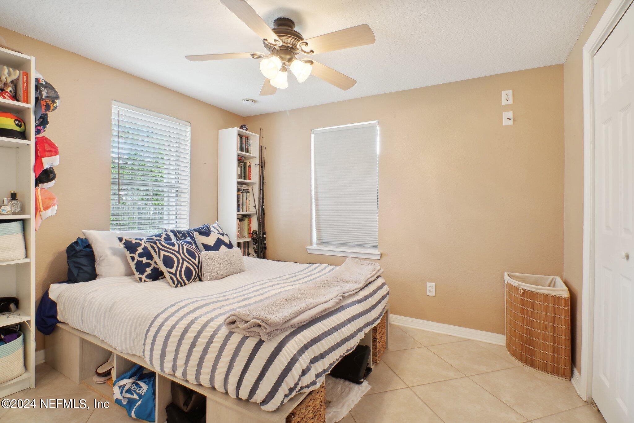 2870 Adams Road St. Augustine, FL 32092 - Photo 24 of 31 a bedroom with a bed and a chandelier