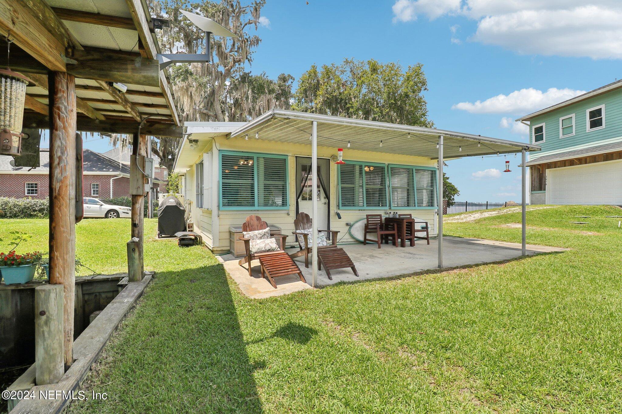 2870 Adams Road St. Augustine, FL 32092 - Photo 3 of 31 a view of a backyard with a patio and a garden
