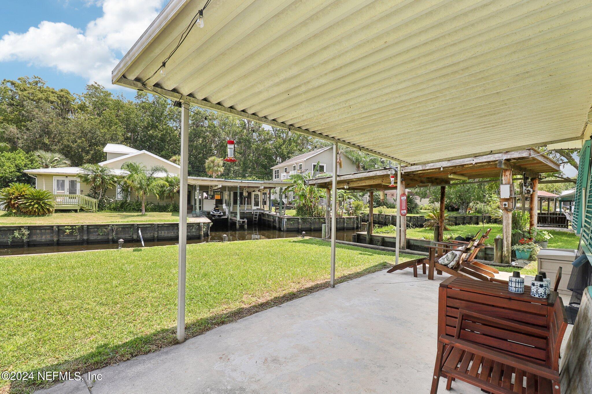 2870 Adams Road St. Augustine, FL 32092 - Photo 8 of 31 a view of a patio with chairs and a yard