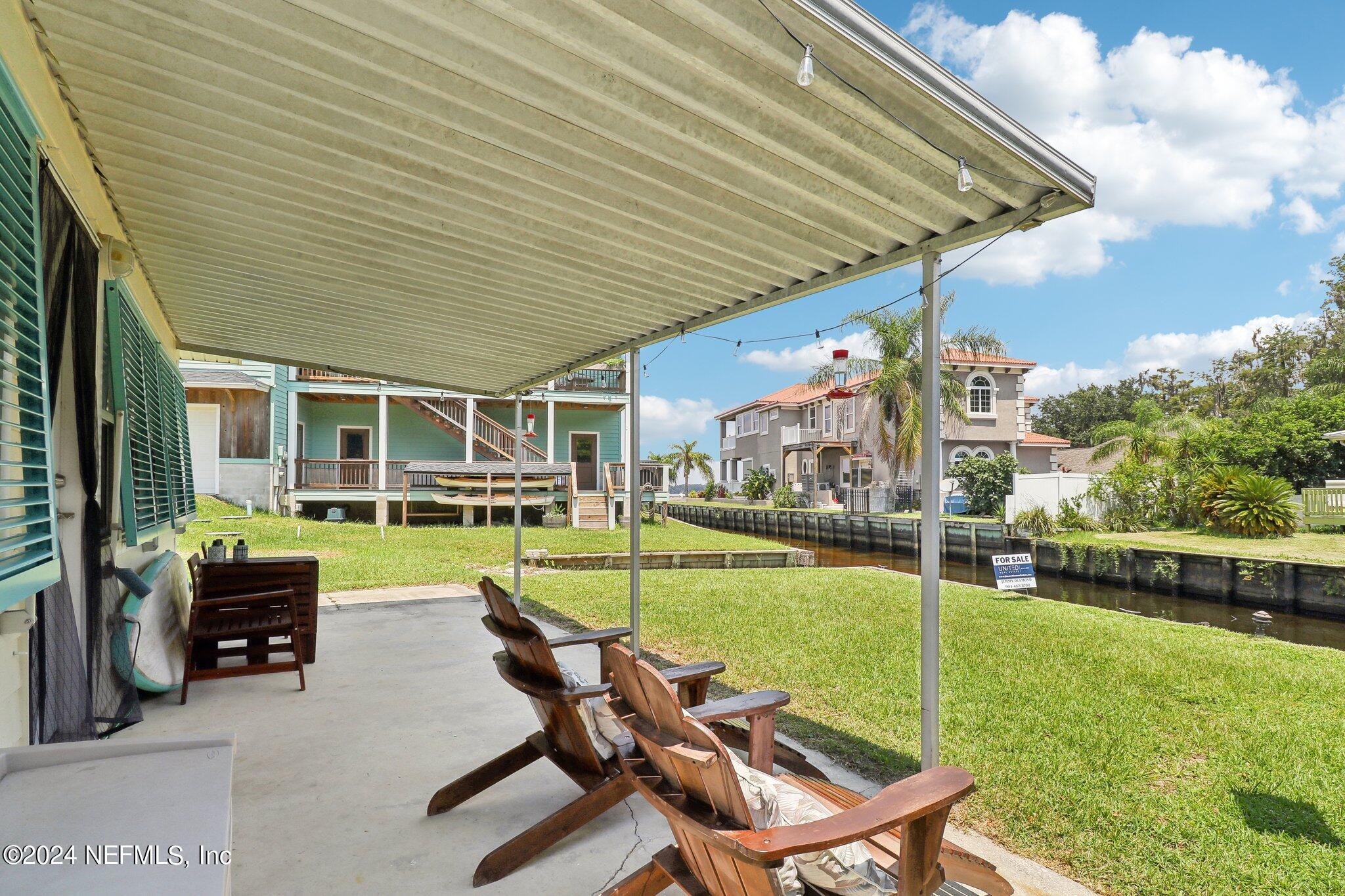 2870 Adams Road St. Augustine, FL 32092 - Photo 9 of 31 a swimming pool with outdoor seating and yard