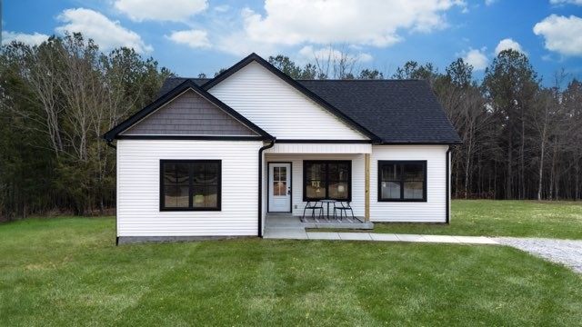 1280 Old County House Road Charlotte, TN 37036 - Photo 2 of 26 a front view of a house with a yard