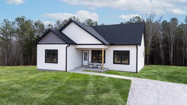 1280 Old County House Road Charlotte, TN 37036 - Photo 22 of 26 a front view of house with a garden and yard