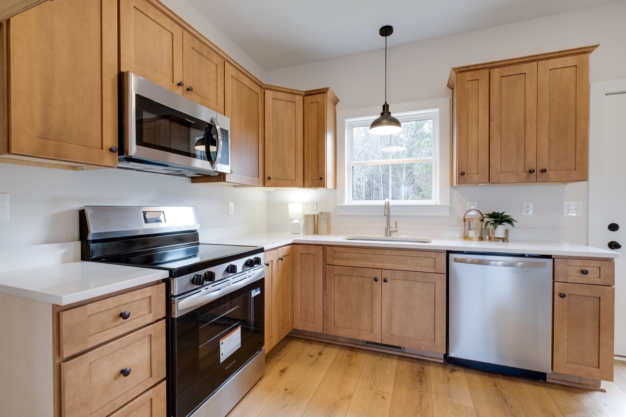 1280 Old County House Road Charlotte, TN 37036 - Photo 7 of 26 a kitchen with stainless steel appliances granite countertop a sink a stove a microwave and wooden cabinets