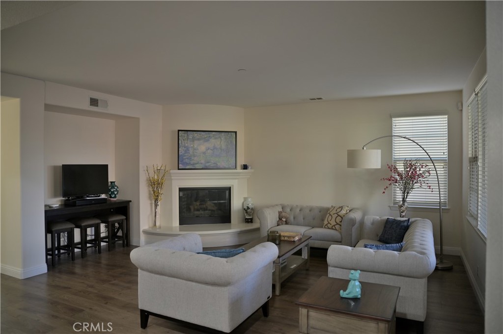 7112 Acorn Place Rancho Cucamonga, CA 91739 - Photo 11 of 40 a living room with furniture a fireplace and a flat screen tv