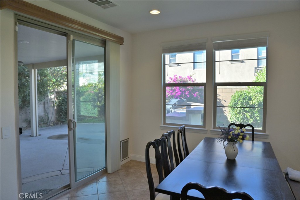7112 Acorn Place Rancho Cucamonga, CA 91739 - Photo 12 of 40 a view of a dining room with furniture window and wooden floor