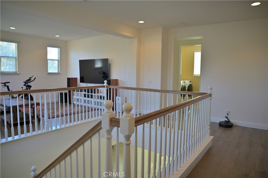 7112 Acorn Place Rancho Cucamonga, CA 91739 - Photo 17 of 40 a view of staircase with wooden floor and windows