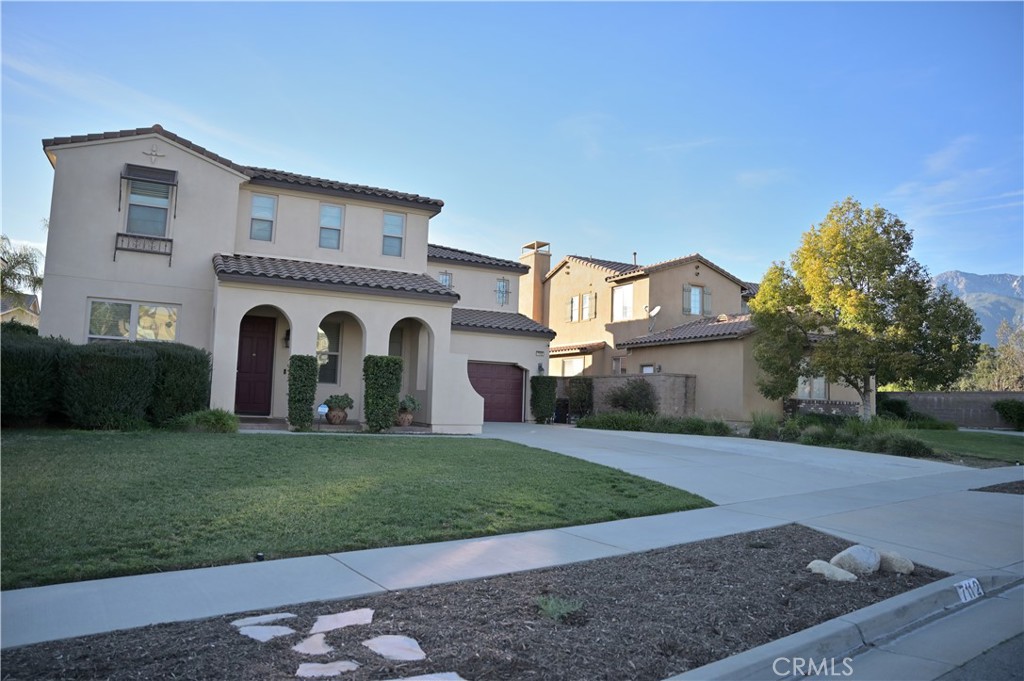 7112 Acorn Place Rancho Cucamonga, CA 91739 - Photo 2 of 40 a view of a white house with a yard
