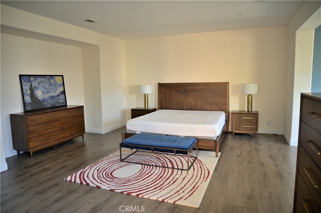 7112 Acorn Place Rancho Cucamonga, CA 91739 - Photo 22 of 40 a bedroom with a bed and wooden floor