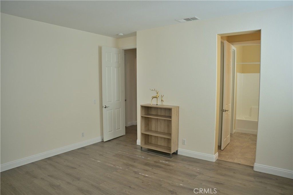 7112 Acorn Place Rancho Cucamonga, CA 91739 - Photo 29 of 40 a view of an empty room and wooden floor
