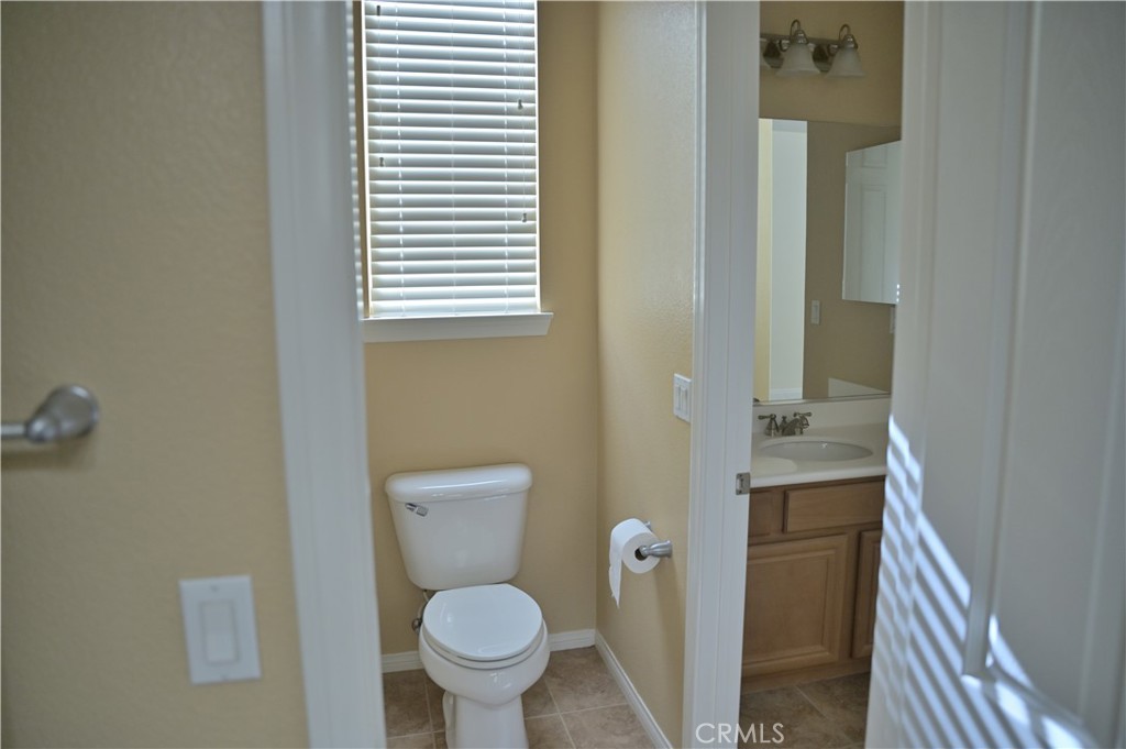 7112 Acorn Place Rancho Cucamonga, CA 91739 - Photo 31 of 40 a bathroom with a granite countertop toilet and a sink