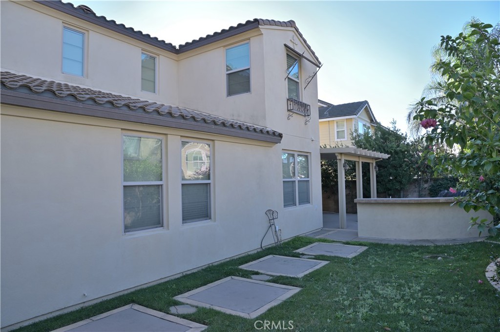 7112 Acorn Place Rancho Cucamonga, CA 91739 - Photo 35 of 40 a front view of a house with a yard and garage
