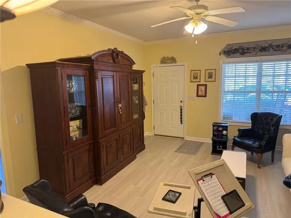 a view of a workspace with furniture and a window