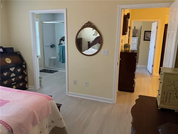 a bedroom with a bed and a mirror